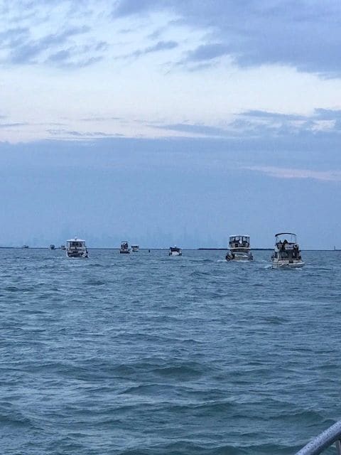 Flotilla leaving Hammond for Joliet, Chicago skyline in background