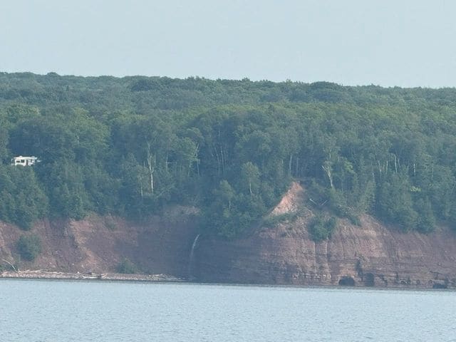 Land in sight! Coming up to the Portage Waterway. (Note the waterfall!)
